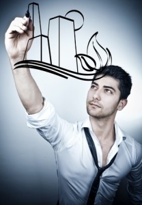 Young business man drawing a eco-friendly city on a glass board